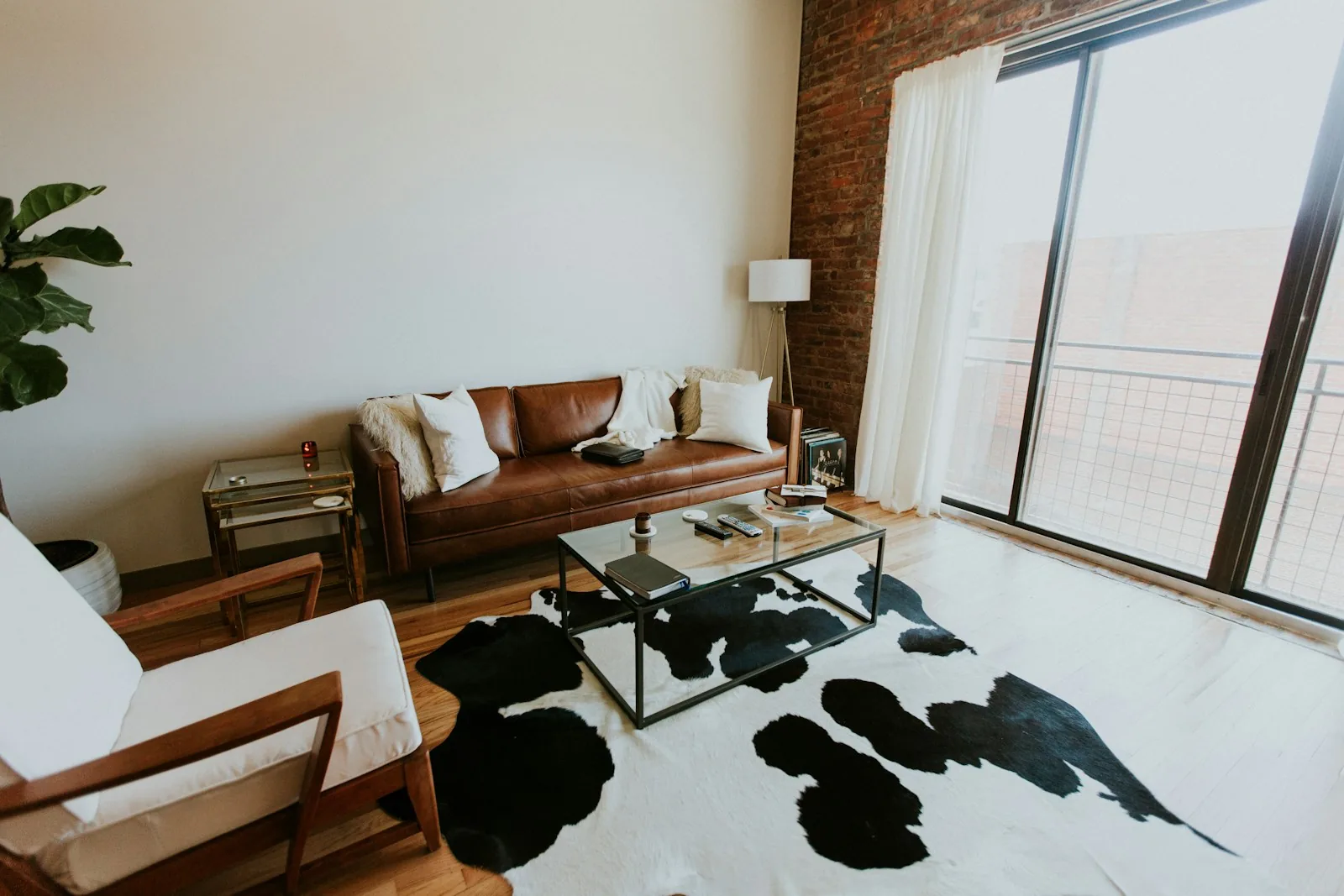 Furnished living room with seating, tables and plants