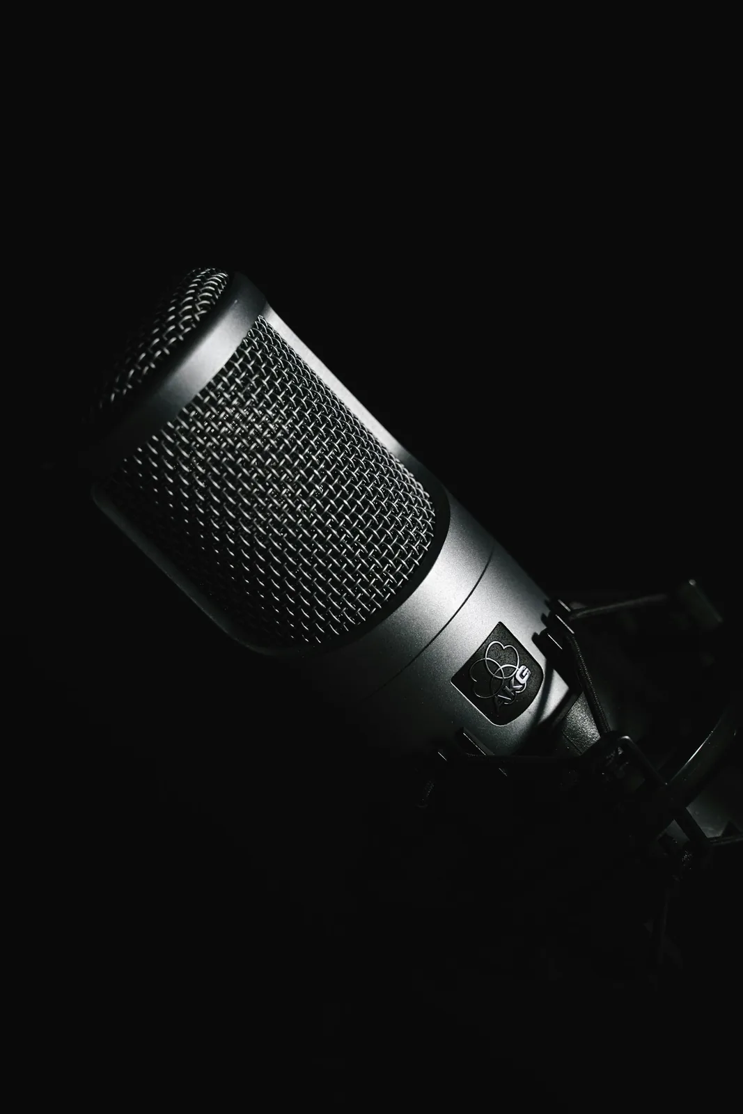 Black studio recording microphone on a dark background