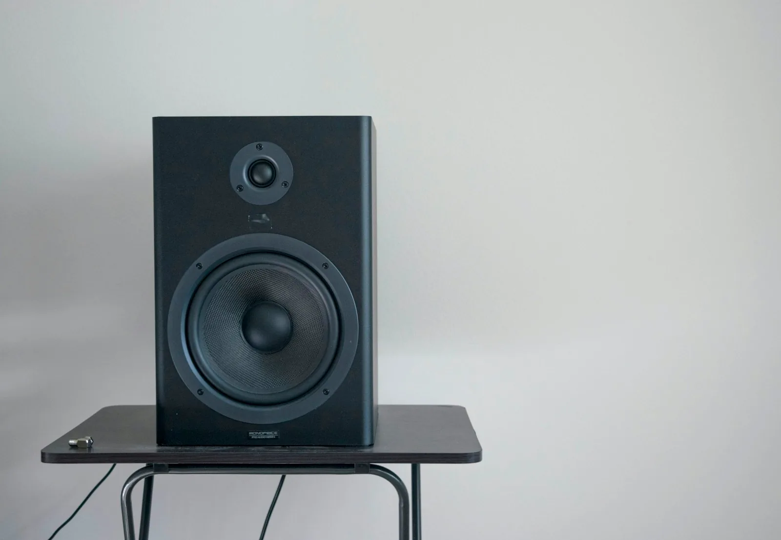 Studio loudspeaker on a table beside a window