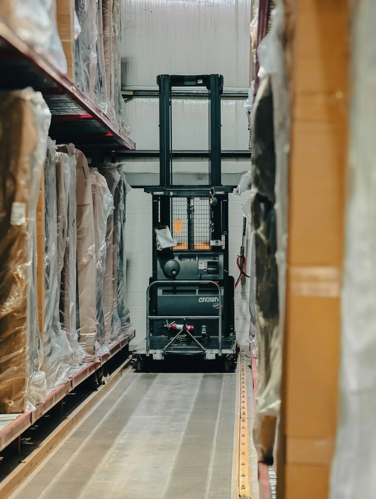 Warehouse aisle with shelving, boxes and pallets